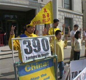 10-year-old Ben Chen stands next to his mother and other Falun Gong practitioners as they perform meditation exercises in front of the embassy. (photo courtesy of Minghui.org)